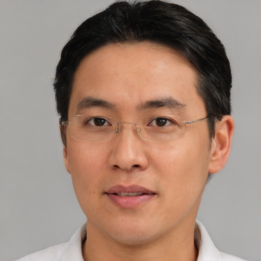 Joyful asian adult male with short  black hair and brown eyes
