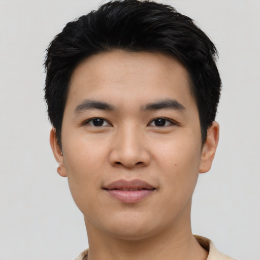 Joyful asian young-adult male with short  black hair and brown eyes