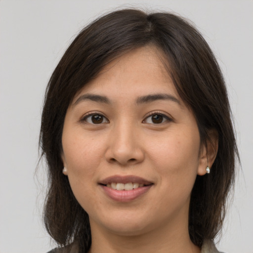 Joyful white young-adult female with medium  brown hair and brown eyes