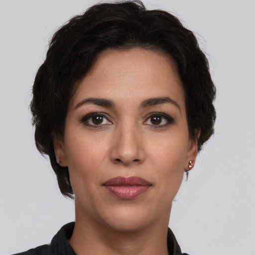Joyful latino young-adult female with short  brown hair and brown eyes