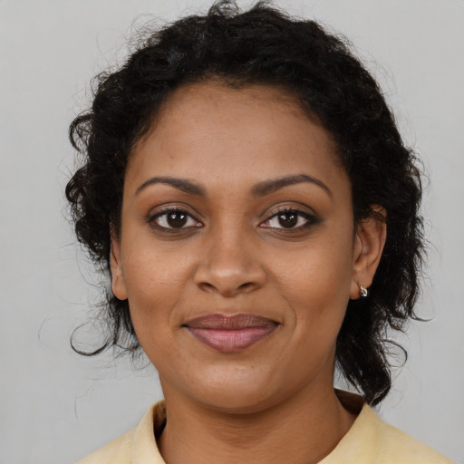 Joyful black young-adult female with medium  brown hair and brown eyes