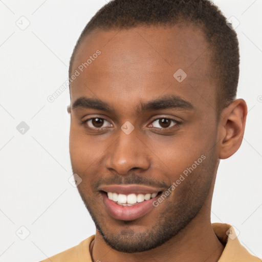 Joyful black young-adult male with short  brown hair and brown eyes