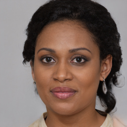 Joyful black adult female with medium  brown hair and brown eyes