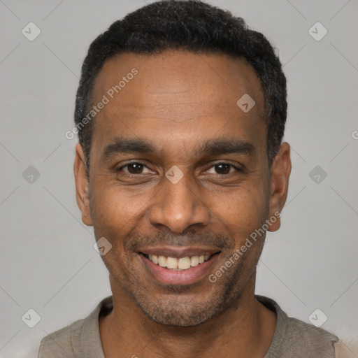 Joyful black young-adult male with short  black hair and brown eyes