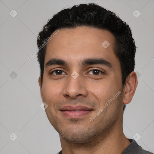 Joyful white young-adult male with short  black hair and brown eyes