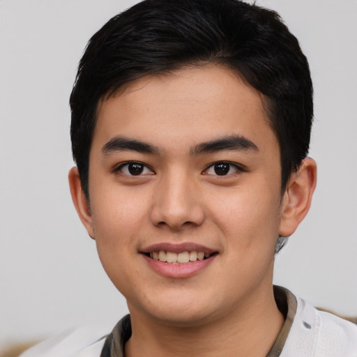 Joyful asian young-adult male with short  brown hair and brown eyes