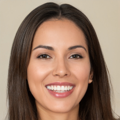 Joyful white young-adult female with long  brown hair and brown eyes