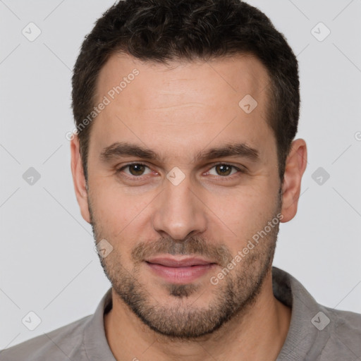 Joyful white young-adult male with short  brown hair and brown eyes