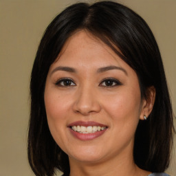 Joyful asian young-adult female with medium  brown hair and brown eyes