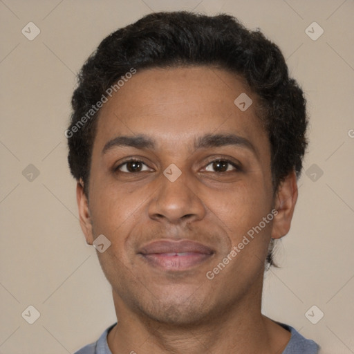 Joyful black young-adult male with short  brown hair and brown eyes