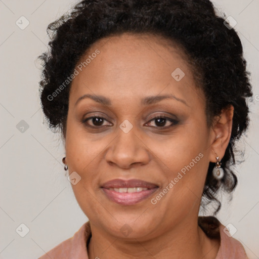 Joyful black adult female with medium  brown hair and brown eyes