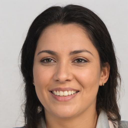 Joyful white young-adult female with long  brown hair and brown eyes