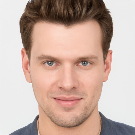 Joyful white young-adult male with short  brown hair and grey eyes