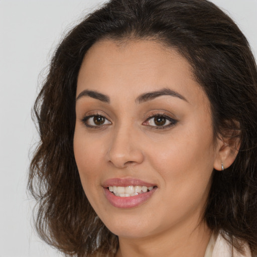 Joyful white young-adult female with long  brown hair and brown eyes