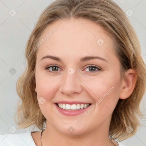 Joyful white young-adult female with medium  brown hair and blue eyes