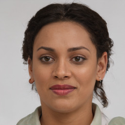 Joyful black young-adult female with medium  brown hair and brown eyes