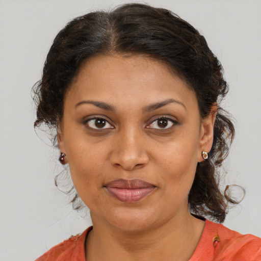 Joyful black young-adult female with medium  brown hair and brown eyes