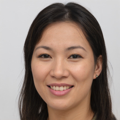 Joyful white young-adult female with long  brown hair and brown eyes