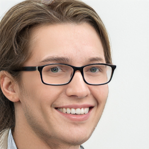 Joyful white young-adult male with long  brown hair and blue eyes