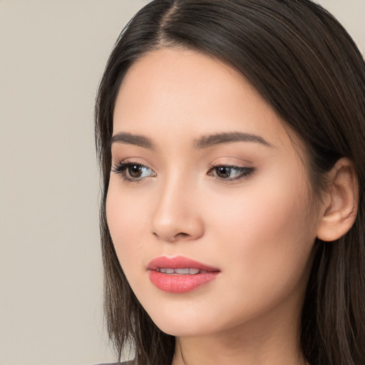 Joyful white young-adult female with long  black hair and brown eyes