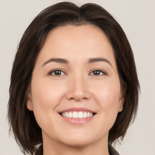 Joyful white young-adult female with medium  brown hair and brown eyes