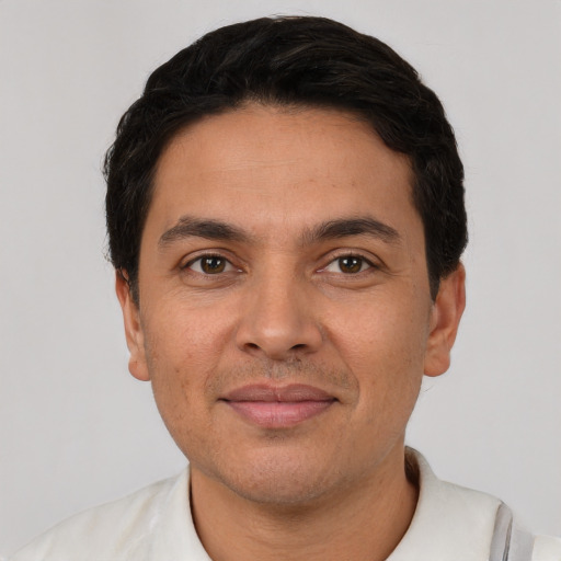 Joyful white young-adult male with short  black hair and brown eyes