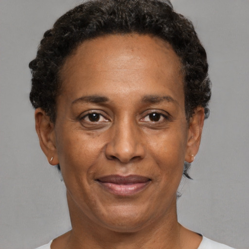 Joyful black adult female with short  brown hair and brown eyes