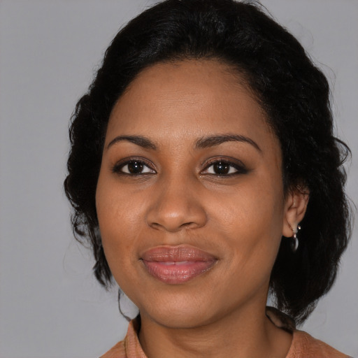 Joyful black adult female with medium  black hair and brown eyes