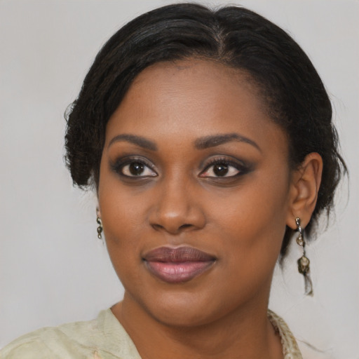 Joyful black young-adult female with medium  brown hair and brown eyes