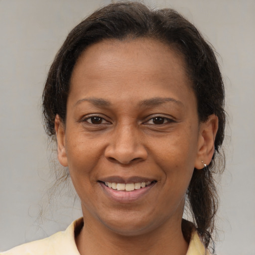 Joyful latino adult female with medium  brown hair and brown eyes