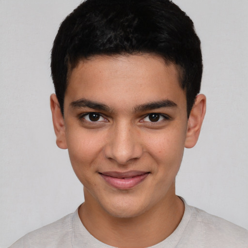 Joyful white young-adult male with short  black hair and brown eyes