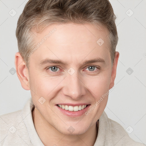 Joyful white young-adult male with short  brown hair and grey eyes