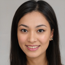 Joyful asian young-adult female with long  brown hair and brown eyes