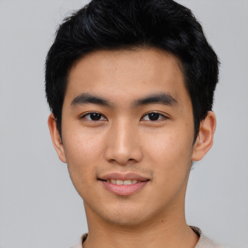 Joyful asian young-adult male with short  black hair and brown eyes