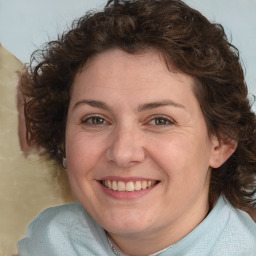 Joyful white adult female with medium  brown hair and blue eyes