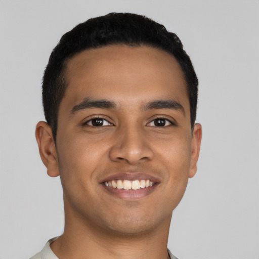 Joyful latino young-adult male with short  black hair and brown eyes