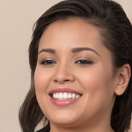 Joyful white young-adult female with long  brown hair and brown eyes