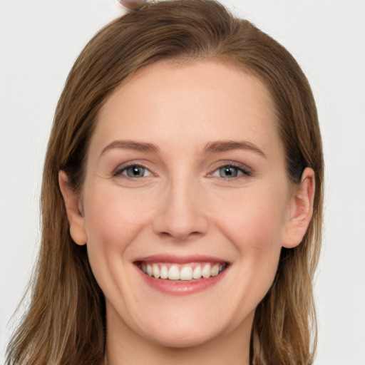 Joyful white young-adult female with long  brown hair and grey eyes