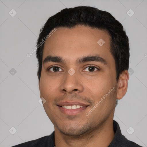 Joyful white young-adult male with short  black hair and brown eyes