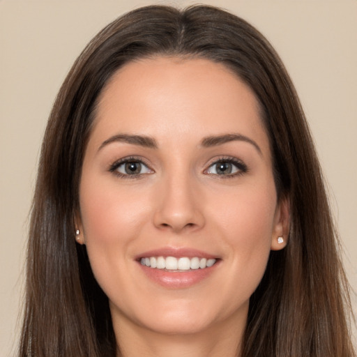 Joyful white young-adult female with long  brown hair and brown eyes