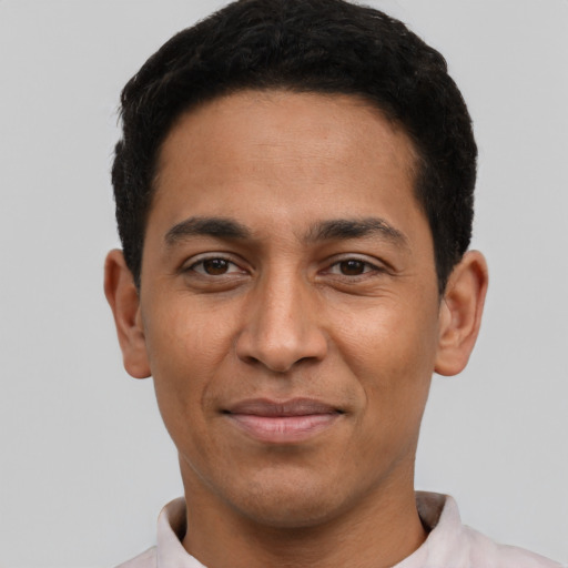 Joyful latino young-adult male with short  black hair and brown eyes