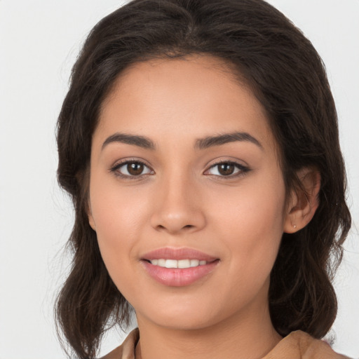 Joyful white young-adult female with long  brown hair and brown eyes