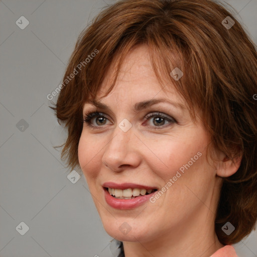 Joyful white adult female with medium  brown hair and brown eyes