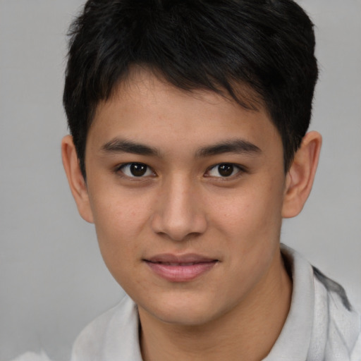 Joyful asian young-adult male with short  brown hair and brown eyes