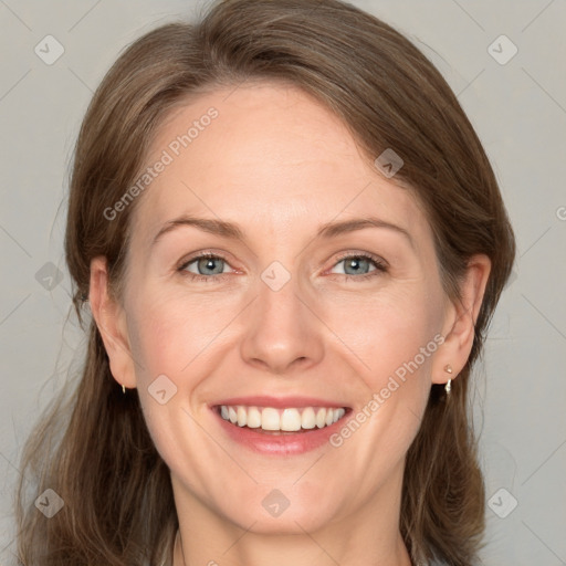 Joyful white adult female with medium  brown hair and grey eyes