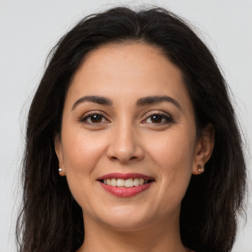 Joyful white young-adult female with long  brown hair and brown eyes