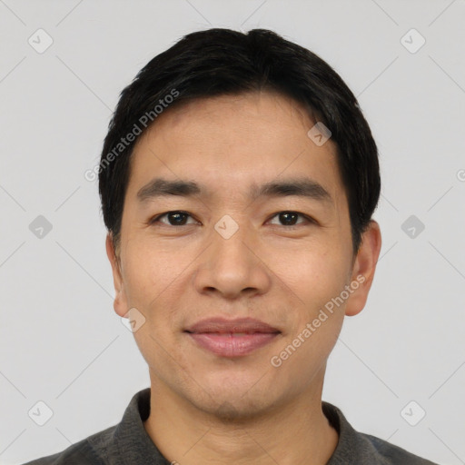 Joyful asian young-adult male with short  black hair and brown eyes