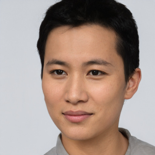 Joyful asian young-adult male with short  black hair and brown eyes