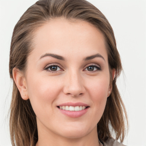 Joyful white young-adult female with long  brown hair and grey eyes