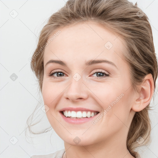 Joyful white young-adult female with medium  brown hair and blue eyes